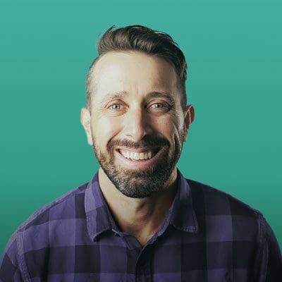 Doctor Moffatt with plaid shirt and green background